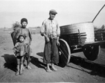 Rural farm people with their donkey cart. At the north end of the field, Yangkai, Spring 1944. During WWII.  From the collection of Frank Bates