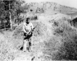"Fred Nash, several miles south of Yangkai, in a group of burial mounds, just before having lunch. Spring, 1945."  From collection of Frank Bates.
