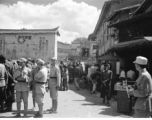 Market At Luliang, China, not far from American base, during WWII. Note the Nationalist propaganda on the facing wall.