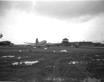 Base, planes, and control Tower at an American base in China during WWII. Local people in Yunnan province, China, most likely around the Luliang air base area.