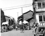 Market crowded with local people in in Kunming city, Yunnan province, China. During WWII.