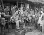 At a hardware stand, GI Fred Nash, with appreciative local people. Yangkai Village, Spring 1945.