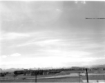 A view across part of American air base at Liuzhou in 1945, after being reoccupied by American and Chinese forces following Japanese withdrawal in 1945. Note apparent B-25 in tidy revetment, driving jeep, and ruins of base buildings, destroyed during Allied retreat, Japanese occupation, and again during Japanese withdrawal.