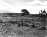 An American serviceman walking  on the hill above Yangkai air base, in Yunnan province, China, during WWII. Note the carbine rifle he carries for protection.