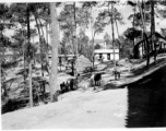 GI explorations of the hostel area at Yangkai air base during WWII: Local people move between the trees and buildings on the base.
