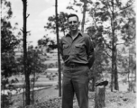 Eugene Wozniak poses among pines at Yangkai air base during WWII.