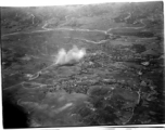 Smokes rises above village, likely in Burma, but possibly in either SW China, or French Indochina during WWII.