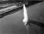 A solitary bomb falls from low altitude in a river, mostly during a run on a bridge, and most likely in French Indochina. During WWII.