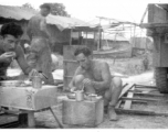 GIs getting chow while on the road or at a camp. During WWII in the CBI.