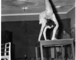 Celebrities visit and perform at Yangkai, Yunnan province, during WWII: Betty Yeaton performs contortionist act.