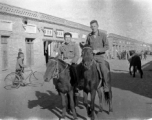 SACO men on mules on the street in Shaanba (陕坝镇), Inner Mongolia, China, during WWII.