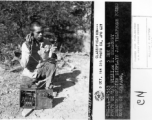 Chinese soldier displays Japanese telephone found north of Zhefang.  December 5, 1944.  Photo by T/5 William E. Shemorry. 164th Signal Photographic Company, APO 627.  Passed by William E. Whitten.