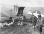 From a C-47 these Chinese are seen unloading food for the Chinese who are building the new road towards the  Burma border to meet the Ledo Road.  December 11, 1944.  Photo by T/Sgt. S. L. Greenberg. 164th Signal Photographic Company, APO 627.  Passed by William E. Whitten.