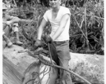 Engineer of the 797th Engineer Forestry Company in Burma, weaving a pulling eye in cable.  During WWII.