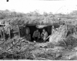 Engineers of the 797th Engineer Forestry Company pose in an old bunker, either American or Japanese.  During WWII.