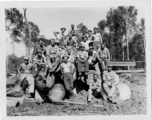 Engineers of the 797th Engineer Forestry Company pose on logs in Burma.  During WWII.
