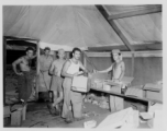 Burma Road engineers pick up goodies at camp in Burma--including Butterfinger bars, soap, chocolate syrup, etc.  During WWII.