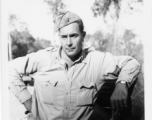 Engineer of the 797th Engineer Forestry Company poses against truck in Burma.  During WWII.