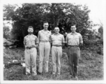 Engineers of the 797th Engineer Forestry Company pose before trees in Burma.  During WWII.