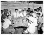 Men gambling at an activity in Burma.  In Burma near the 797th Engineer Forestry Company.  During WWII.