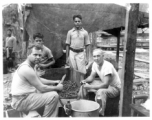 Engineers of the 797th Engineer Forestry Company skin potatoes in KP duty at a camp in Burma. During WWII.