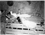 People sleeping inside home in Burma.  In Burma near the 797th Engineer Forestry Company.  During WWII.