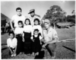 Local people in Burma near the 797th Engineer Forestry Company--GIs pose with man and children in Burma.  During WWII.