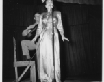 Performers well off the beaten track, providing a break for Burma Road engineers of the 797th Engineer Forestry Company--Jimmy Dodd and Ruth Carrol play guitar and sing.  During WWII.