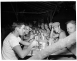 Engineers of the 797th Engineer Forestry Company eating meal at camp in Burma.  During WWII.