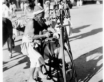 Man sharpens knives on road in town in Burma or India.  Near the 797th Engineer Forestry Company.  During WWII.