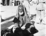 Old man begs on road in town in Burma or India.  Near the 797th Engineer Forestry Company.  During WWII.