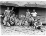 Engineers of the 797th Engineer Forestry Company pose before a building with the sign "VIRGINS HOME" in camp in Burma.  During WWII.