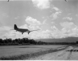 A C-47 transport taking off from an airstrip in Burma.  Aircraft in Burma near the 797th Engineer Forestry Company.  During WWII.