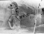 Flyer Walter Wegner poses with B-24 "DER-SCHNOZZE" in this highly damaged image. 10th Air Force, 7th Bombardment Group.  During WWII.