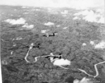 B-25s of the 22nd Bombardment Squadron in flight over thick forests in SW China or Burma during WWII.