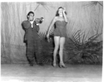 Dancing at a USO show in Gushkara, India, during WWII.  The boxes in front of the band players are labeled 748th ROB (748th Railway Operating Battalion).