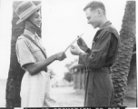 John Wolfshorndl inspects Ghurka knife at an American base in India, during WWII. On the day he had been promoted to Sergeant.