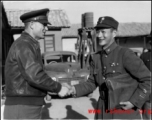 Chinese and American officers shake hands in SW China during WWII.