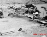 "What One Small Fragmentation Bomb Could Do--This B-24 was hit with one small fragmentation bomb during one of the nightly air raids at Luichow [Liuzhou], China.This particular plane just happened to be a new B-24 that had never flown a mission. As bad as it looks it was not a total loss since the engines were removed, inspected and run-outs done on the crankshafts to be sure they were not damaged. All the engines were used to replace blown engines on the B-24's that were flying gas into China from India. T