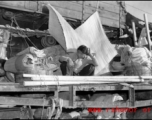 Chinese refugee waits atop flatbed car at the train station in Liuzhou during WWII, in the fall of 1944, as the Japanese advanced during the Ichigo campaign.