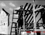 Man building roof of house in SW China during WWII.