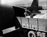 American servicemen load or unload supplies from a US transport plane.  Since, according the stories shared by veterans, African-American servicemen rarely made it into China, this must be outside of China, most likely India or Burma.