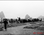 Chinese workers pulling a large roller at a base  in Guangxi province (probably Liuzhou, but maybe Guilin), China.