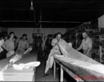 Packing and checking parachutes--a truly vital and exacting task. At an American base, China, during WWII.