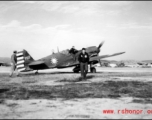 A P-40, tail #752, with nationalist markings, and two American servicemen in the CBI.