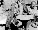 An elderly Chinese man at rest in the CBI, long pipe in hand.  From the collection of Wozniak, combat photographer for the 491st Bomb Squadron, in the CBI.