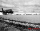A C-46 on a runway in the CBI.  Interestingly, a censor has scratched out the mountains in the background.   From the collection of Robert H. Zolbe.