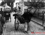 An American serviceman in the CBI riding a rickshaw pulled by a Chinese man.  From the collection of Wozniak, combat photographer for the 491st Bomb Squadron, in the CBI.