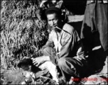 Local people  in China, probably in Yunnan province: A man in rural China with a dog.  From the collection of Wozniak, combat photographer for the 491st Bomb Squadron, in the CBI.