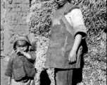 Local people in China, probably in Yunnan province: Woman and child village.